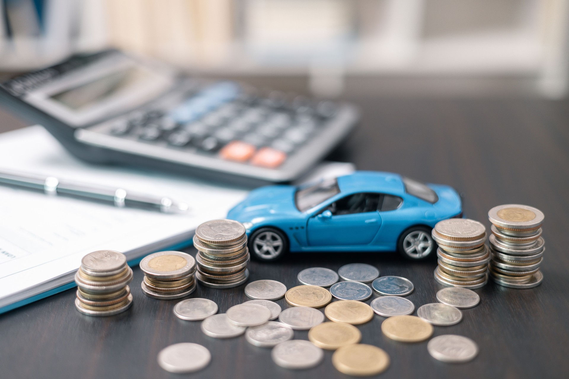 Business concept involved using finance calculator to determine premium for vehicle policy, ensuring clear financial contract for car. Investing in auto insurance can save money on transport costs.